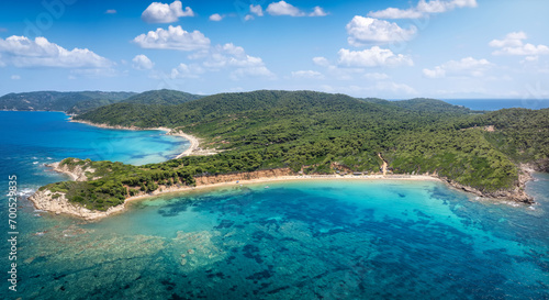 Fototapeta Naklejka Na Ścianę i Meble -  Panoramic aerial view of the beach at Mandraki, Skiathos island, Sporades, Greece, with lush pine tree forest and emerald sea