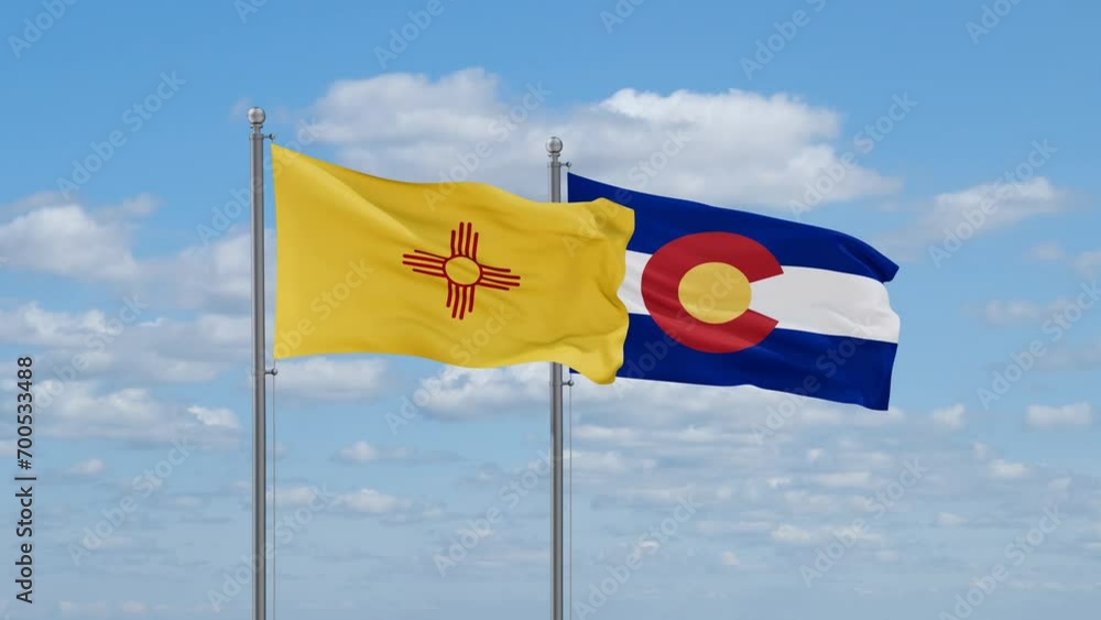 Colorado and New Mexico US state flags waving together on cloudy sky, endless seamless loop