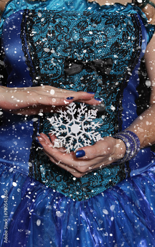 Woman wearing Blue Corset with snowflake ornament and snow storm
