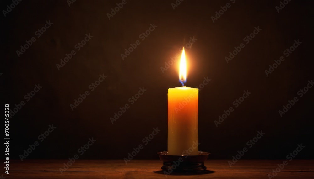 a lit candle sitting on top of a wooden table next to a black wall with a shadow of a candle in the middle of the candle and a black background. a lit candle sitting on top of a wooden table next to a black wall with a shadow of a candle in the middle of the candle and a black background.