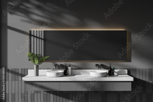 Grey hotel bathroom interior with double sink and minimalist accessories