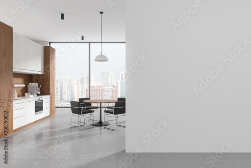 Stylish office interior with kitchen cabinet and eating table. Mockup wall photo