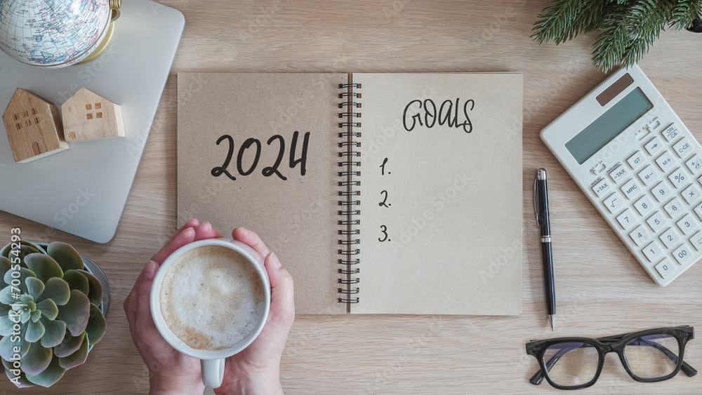 2024 goals new year resolutions on blank note book memo reminder wish list of yearly planner, action plan for work-life balance, good financial health, happy home family, travel aims on office desk - obrazy, fototapety, plakaty 