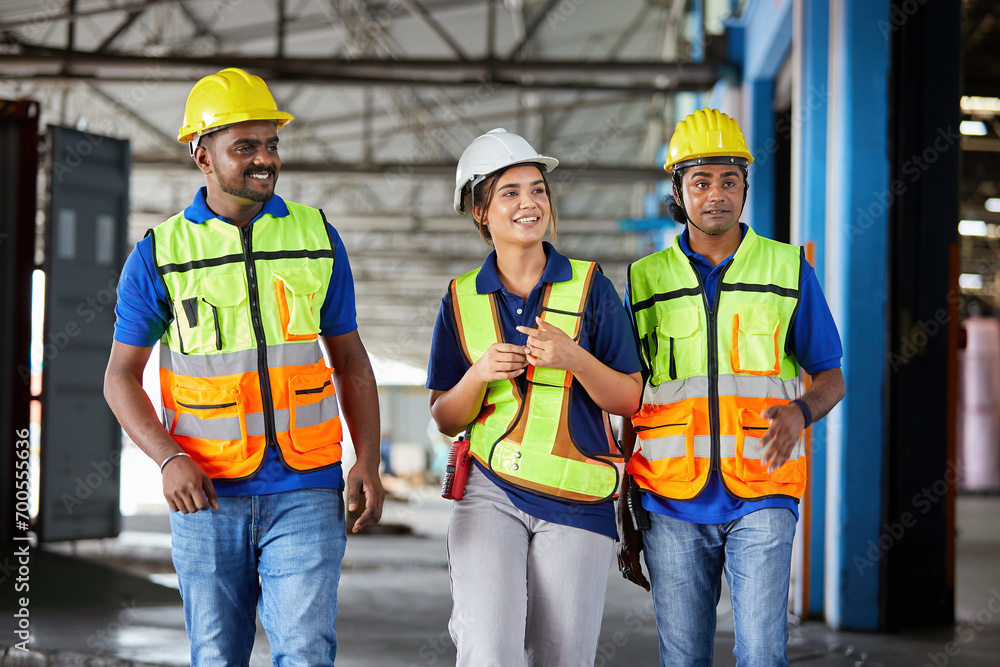 factory workers walking and talking about work or project in the warehouse storage factory workers walking and talking about work or project in the warehouse storage