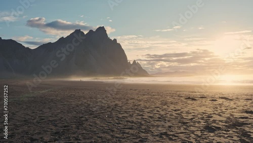 Sunrise over Vestrahorn mountain with reflect on black sand beach in summer at Iceland photo