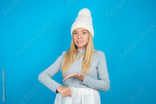 beautiful caucasian teen girl wearing grey sweater In hurry pointing to watch time, impatience, upset and angry for deadline delay.