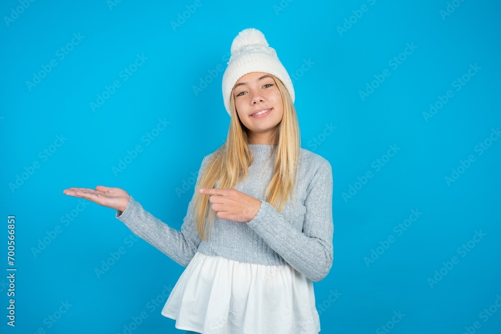 beautiful caucasian teen girl wearing grey sweater pointing and holding hand showing adverts beautiful caucasian teen girl wearing grey sweater pointing and holding hand showing adverts