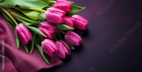 Bouquet of pink tulips on dark background with space for text photo