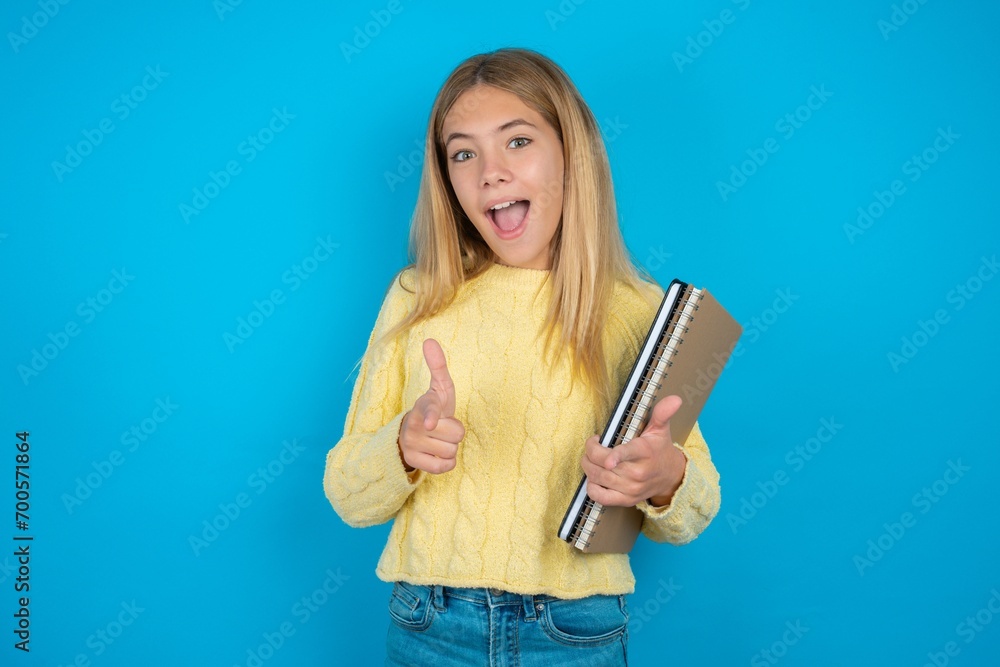 beautiful caucasian teen girl wearing yellow sweater directs fingers at camera selects someone. I recommend you. Best choice beautiful caucasian teen girl wearing yellow sweater directs fingers at camera selects someone. I recommend you. Best choice