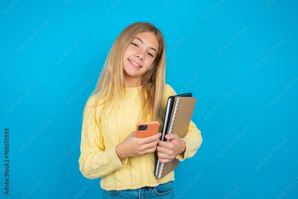 beautiful caucasian teen girl wearing yellow sweater Mock up copy space. Using mobile phone, typing sms message beautiful caucasian teen girl wearing yellow sweater Mock up copy space. Using mobile phone, typing sms message