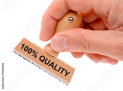 Rubber stamp in hand with the inscription 100 % quality