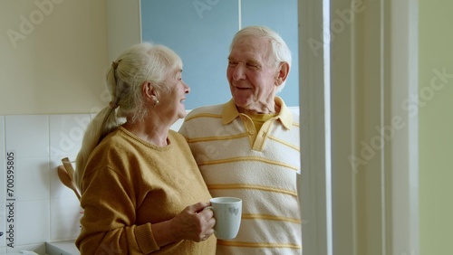 Happy senior man drinking tea with his wife in the morning