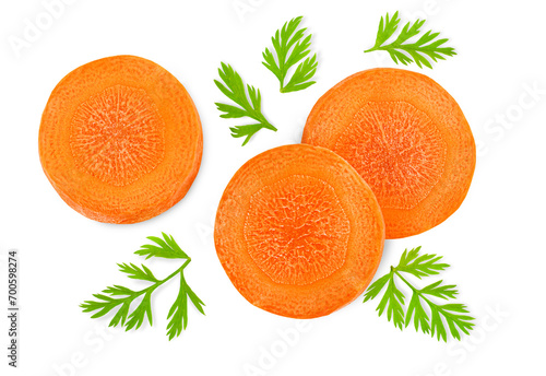 chopped carrot slices with leaves on a white isolated background, top view