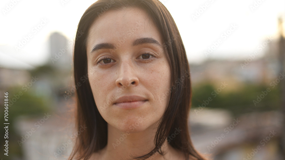 Close up view of white woman looking to camera. Portrait of serious girl standing at sunset light.Concept of people and emotions.
Close up view of white woman looking to camera. Portrait of serious girl standing at sunset light.Concept of people and emotions.