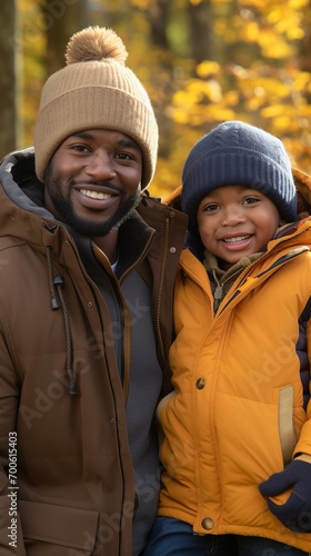 A happy African-American parent and child comes together in the outdoors, capturing warmth and togetherness in a heartwarming portrait #700615403