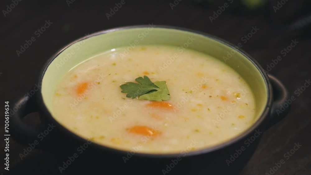 Homemade cream soup in black bowl. Close up. Homemade cream soup in black bowl. Close up.