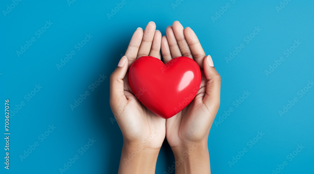 The essence of love with hands presenting a red heart on a serene blue background, an eloquent symbol of affection. Generative AI. The essence of love with hands presenting a red heart on a serene blue background, an eloquent symbol of affection. Generative AI.