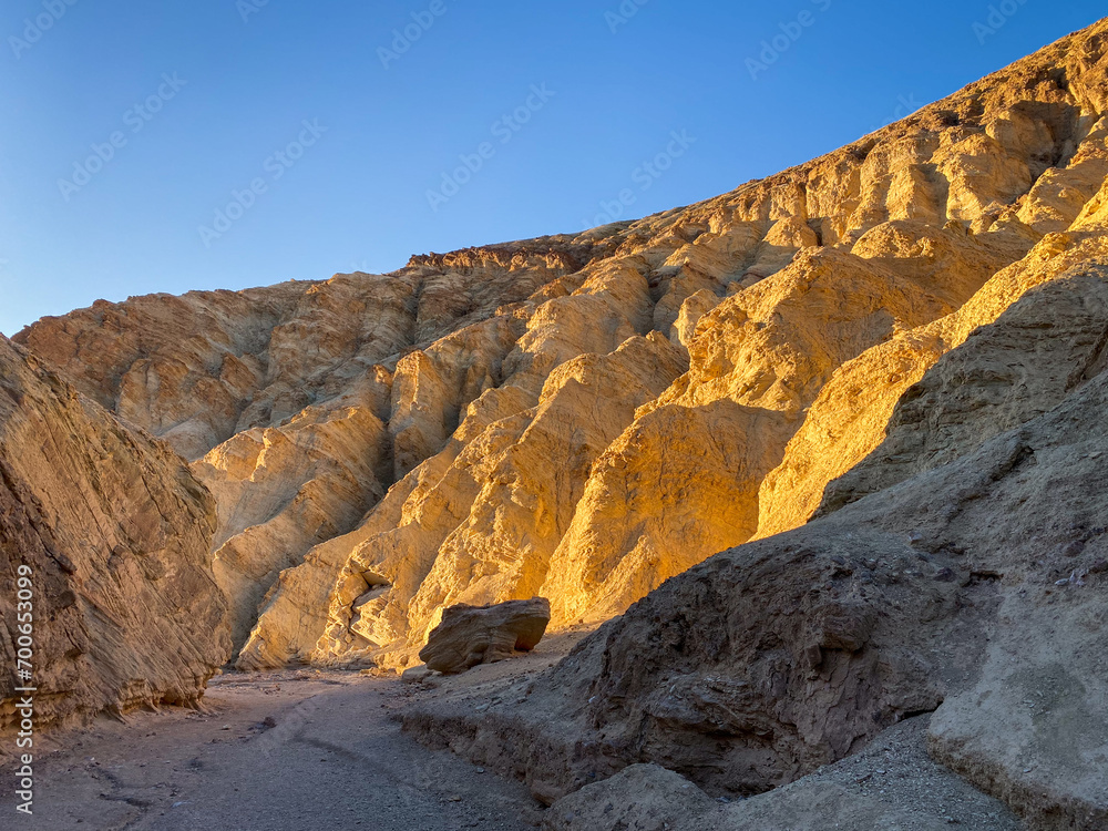 Fototapeta premium Beautiful golden sunset at Golden Canyon at Death valley during winter. CA, USA