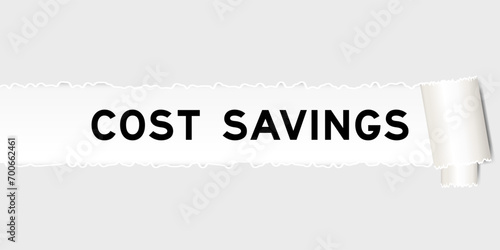 Ripped gray paper background that have word cost savings under torn part