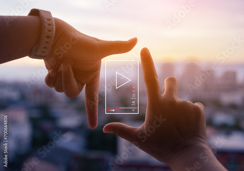 vertical video or short video marketing concept. Photo sign made by human hands on blurred sunset sky as background. photo