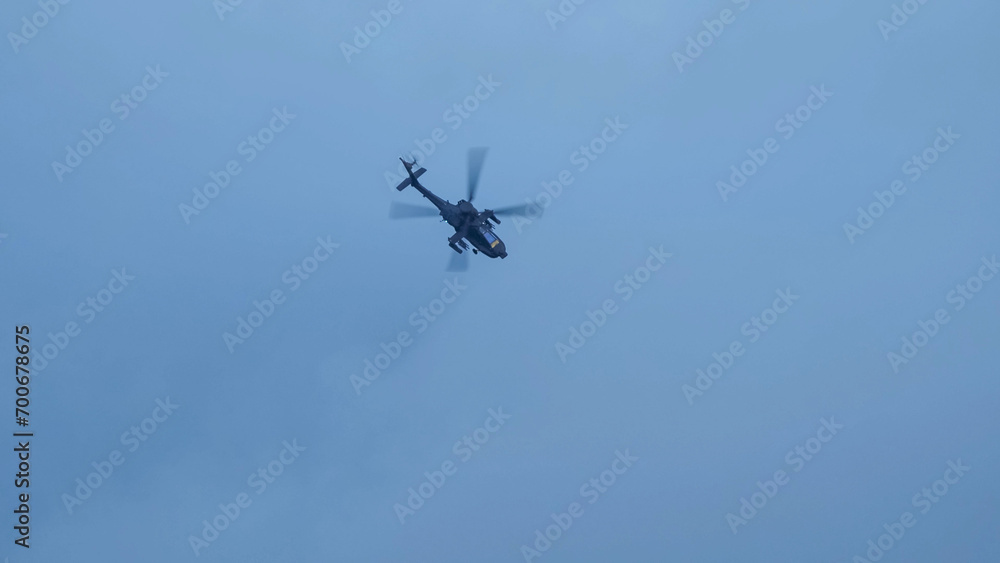 British army Boeing Apache Attack helicopter gunship AH64E (AH-64E ArmyAir606) at full bank in a hammerhead stall turn, Wiltshire UK British army Boeing Apache Attack helicopter gunship AH64E (AH-64E ArmyAir606) at full bank in a hammerhead stall turn, Wiltshire UK