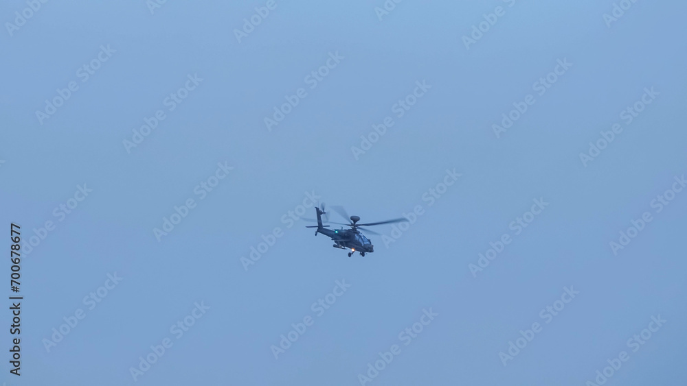 British army Boeing Apache Attack helicopter gunship AH64E (AH-64E ArmyAir606) at full bank in a hammerhead stall turn, Wiltshire UK British army Boeing Apache Attack helicopter gunship AH64E (AH-64E ArmyAir606) at full bank in a hammerhead stall turn, Wiltshire UK