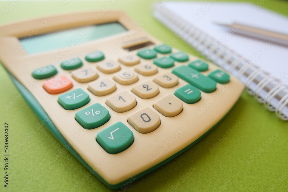 Calculator, note and pen close up Calculator, note and pen close up