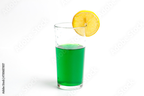 Glass with pure water and lemon on a white background
