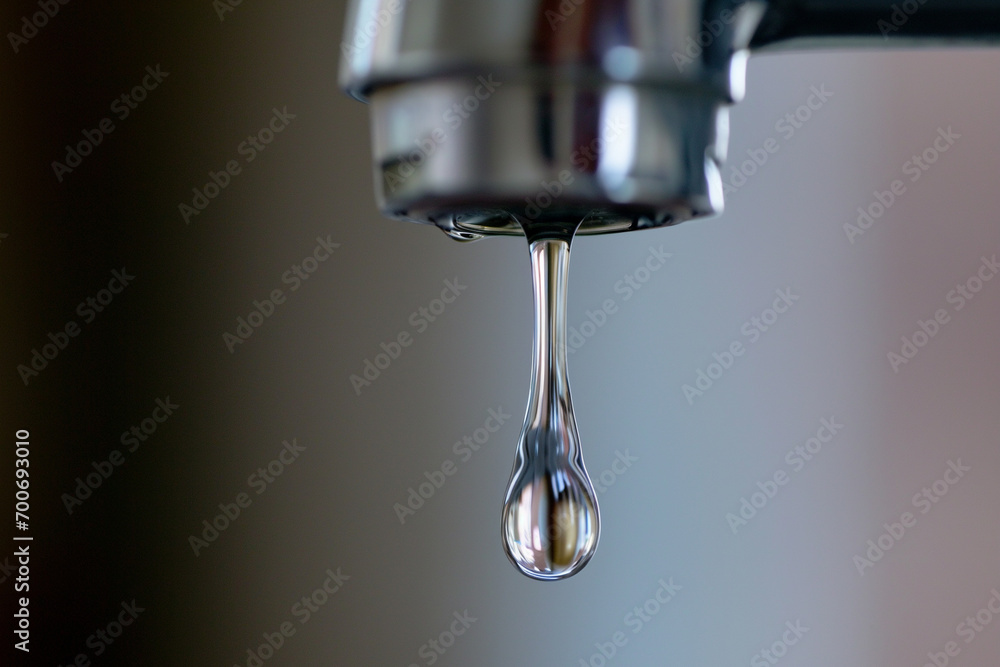 Faucet with drop of water, close up of water drop Faucet with drop of water, close up of water drop
