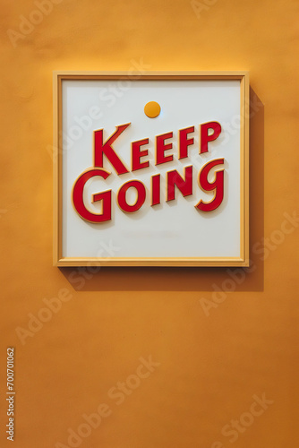 keep going sign in front of yellow wall with copy space