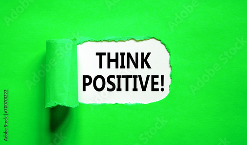 Think positive symbol. Concept words Think positive on beautiful white paper. Beautiful green table green background. Business, motivational think positive thinking concept. Copy space.