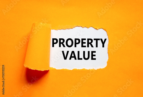 Property value symbol. Concept words Property value on beautiful white paper. Beautiful orange paper background. Business property value concept. Copy space.