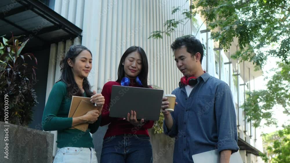 Happy young asian students chatting with each other after class standing outside. Guy and girls wear casual clothes to study. Lifestyle concept. Happy young asian students chatting with each other after class standing outside. Guy and girls wear casual clothes to study. Lifestyle concept.