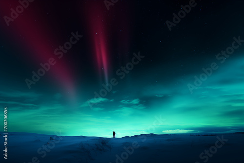 people walk outside tent with Northern Lights in the sky