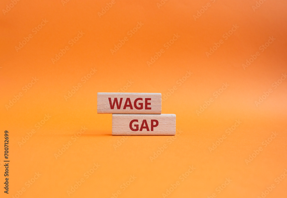 Wage Gap symbol. Concept words Wage Gap on wooden blocks. Beautiful orange background. Business and Wage Gap concept. Copy space. Wage Gap symbol. Concept words Wage Gap on wooden blocks. Beautiful orange background. Business and Wage Gap concept. Copy space.
