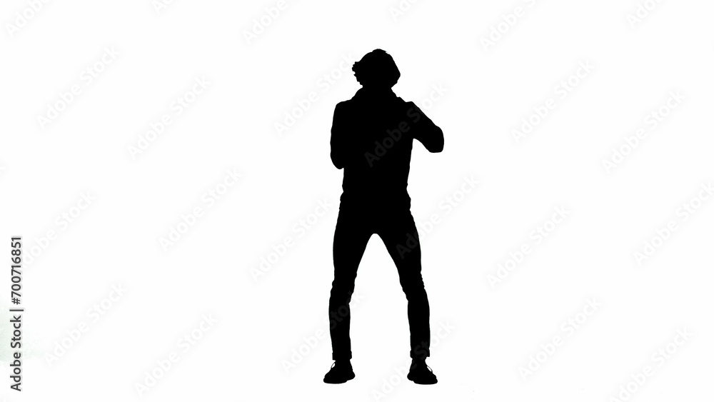 Silhouette of a male activist isolated on a white alpha channel. A Protestant man holds a megaphone near his mouth.