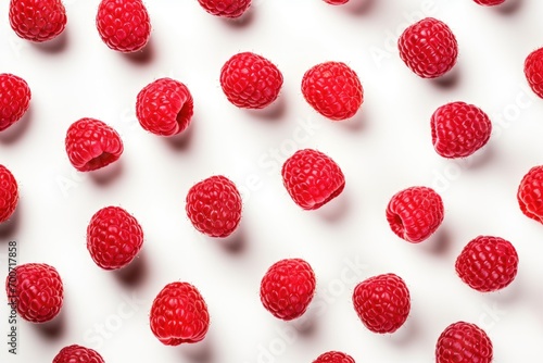 A bunch of raspberries on a white surface