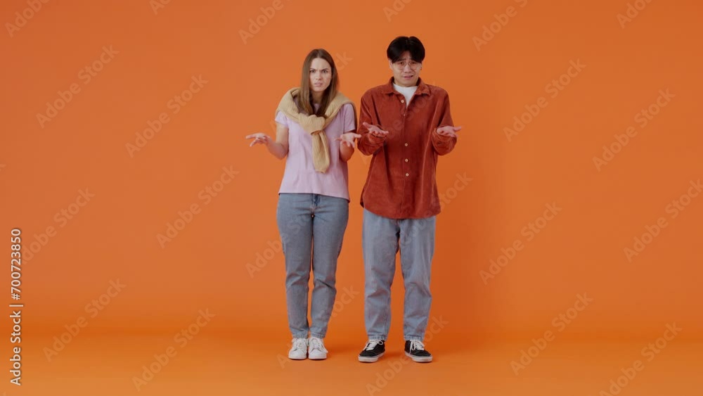 Couple of European woman and Asian man looks in surprise Couple of European woman and Asian man looks in surprise