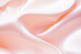 Light pink silk or satin wavy background beautiful and luxurious Space for design. Close-up. Blurred or blurry.