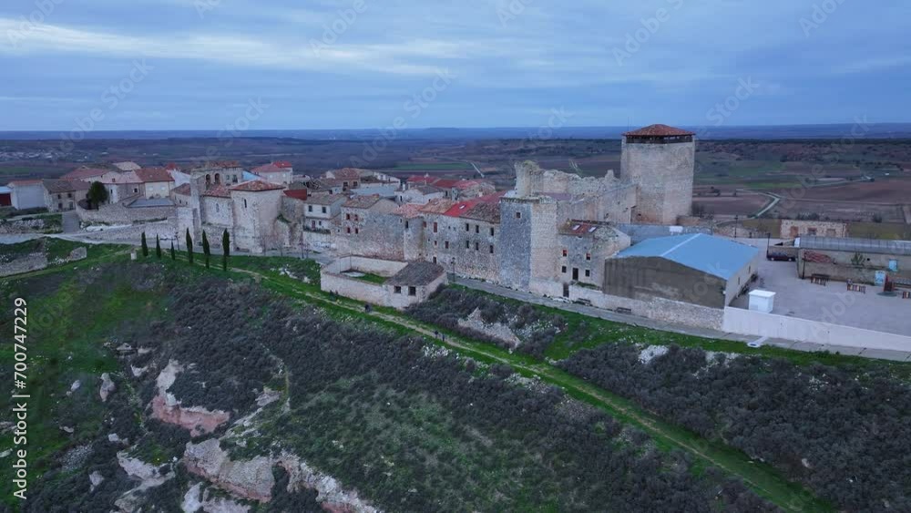 Village and castle of the town of Haza at dusk. Aerial landscape seen from a drone. Haza town. Province of Burgos. Castile and Leon. Spain. Europe Village and castle of the town of Haza at dusk. Aerial landscape seen from a drone. Haza town. Province of Burgos. Castile and Leon. Spain. Europe