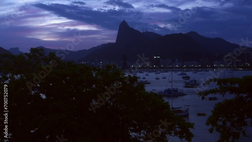 High perspective timelapse of Botafogo Bay in Rio de Janeiro, Brazil at sunset with iconic Christ the Redeemer Statue visible - UNESCO World Heritage Site photo