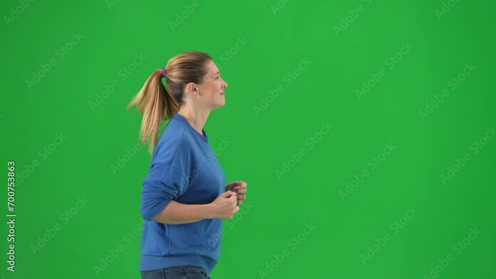 A woman in casual clothes running on the green screen close up. Side view of a woman jogging. Advertising, promo, chroma key. A woman in casual clothes running on the green screen close up. Side view of a woman jogging. Advertising, promo, chroma key.