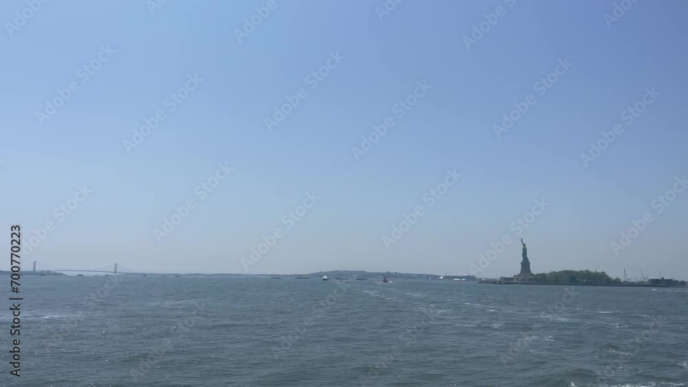 Sailing in New York Bay with the Big Apple skyline and the Statue of Liberty in the background, on a sunny, blue Manhattan day. Sailing in New York Bay with the Big Apple skyline and the Statue of Liberty in the background, on a sunny, blue Manhattan day.