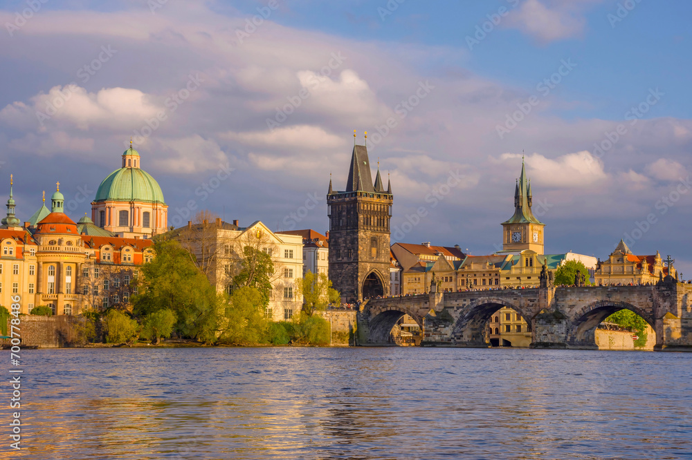 Charles Bridge (Karluv Most) on Vltava river and Old Town Bridge Tower, famous tourist destination in Prague, Czech Republic (Czechia), at sunset