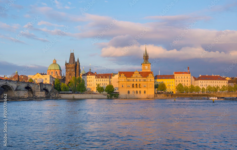 View of old town with Charles Bridge (Karluv Most) on Vltava river and Old Town Bridge Tower, famous tourist destination in Prague, Czech Republic (Czechia), at sunset