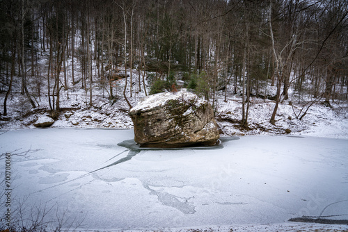 large rock in frozen water