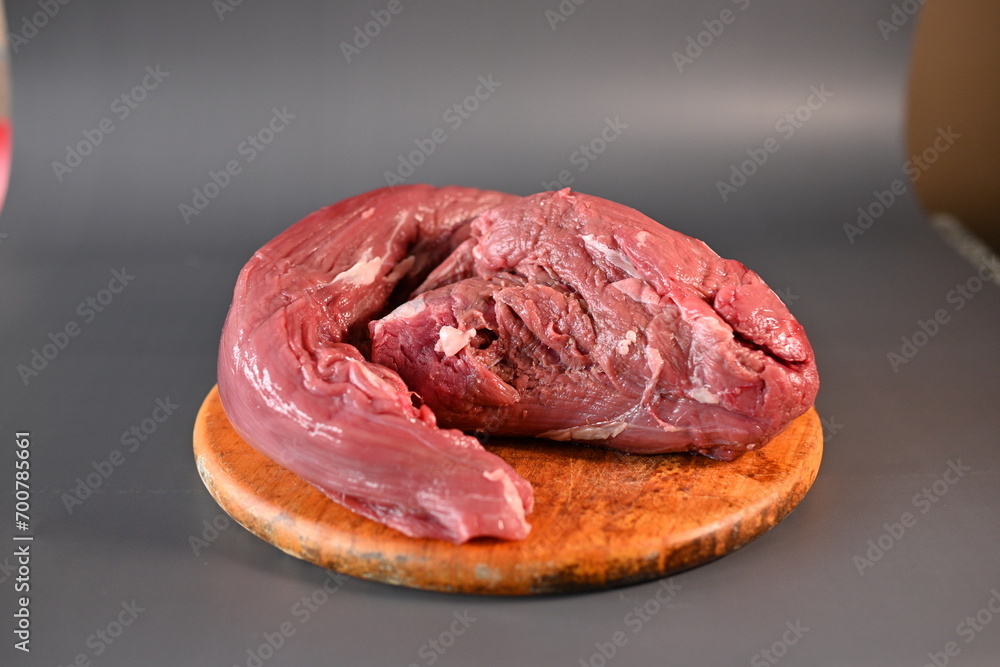 fresh beef tenderloin on a gray background fresh beef tenderloin on a gray background