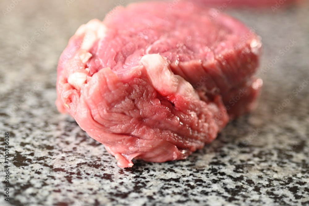 slices of red sliced beef meat, beef tenderloin, red meat on a grey background slices of red sliced beef meat, beef tenderloin, red meat on a grey background