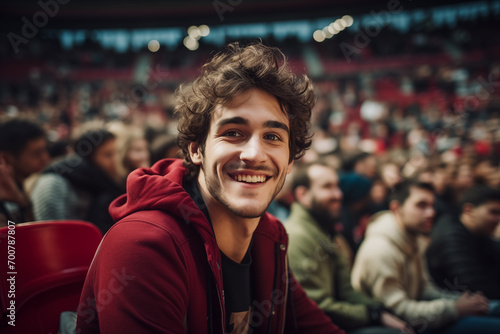 Young Spanish man enjoying a game of basketball in a crowded stadium among other fans
