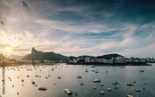 Aerial view of Botafogo Bay in Rio de Janeiro, Brazil at sunset with iconic Christ the Redeemer Statue visible as well as neighbourhoods of Flamengo and downtown photo